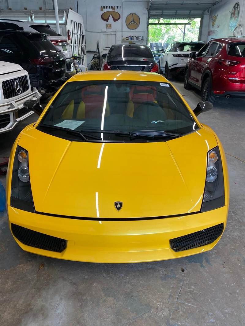 Yellow Lamborghini Gallardo inside Gold Coast Collision Center for body repair