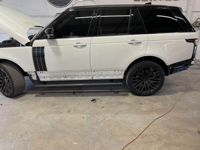 White Range Rover with the doors stripped for side panel collision repair at Gold Coast Collision Center