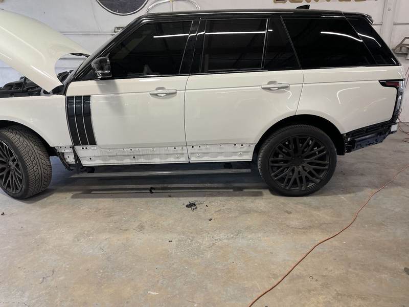 White Range Rover with the doors stripped for side panel collision repair at Gold Coast Collision Center